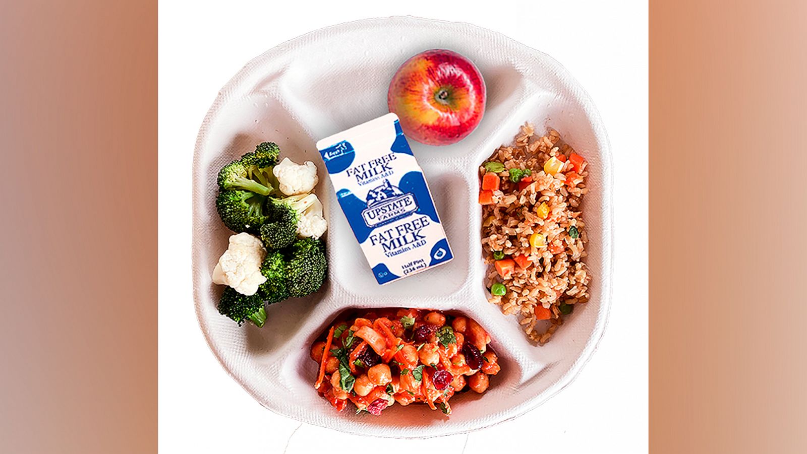 PHOTO: This photo provided by the New York City Department of Education, on Feb. 4, 2022, shows Mediterranean chickpeas, served with rice or pasta, roasted cauliflower and broccoli, salad bar spinach and cranberry salad vegan school lunch.