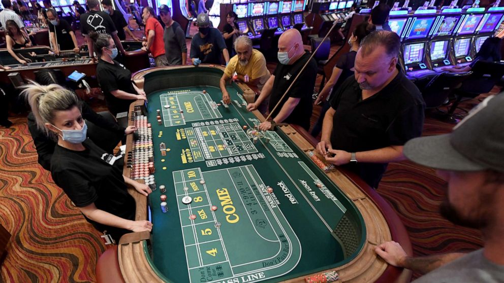 PHOTO: Guests play craps at the Red Rock Resort after the property opened for the first time since being closed on March 17 because of the coronavirus (COVID-19) pandemic on June 4, 2020 in Las Vegas.