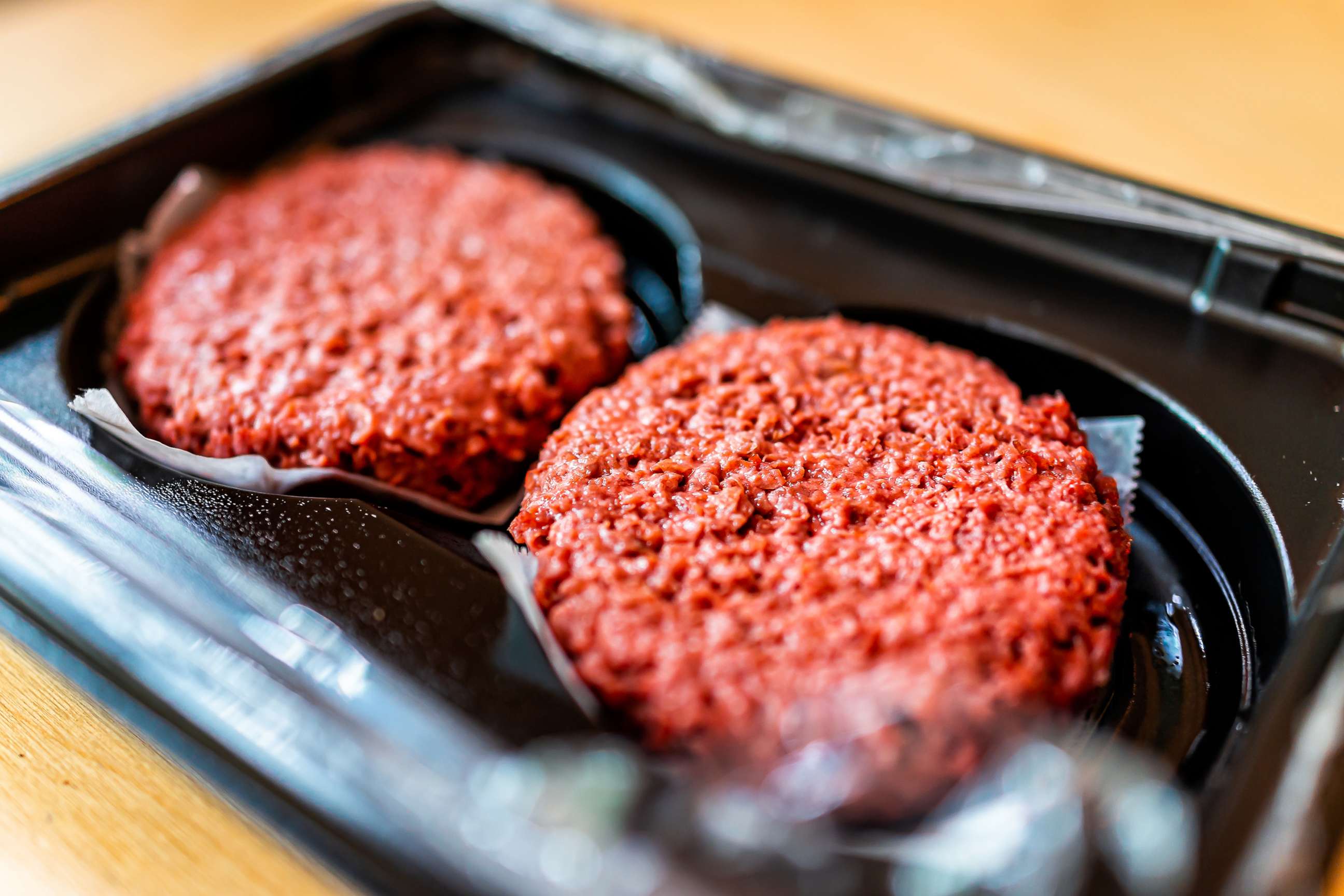 PHOTO: Closeup of two uncooked vegan burger patties.