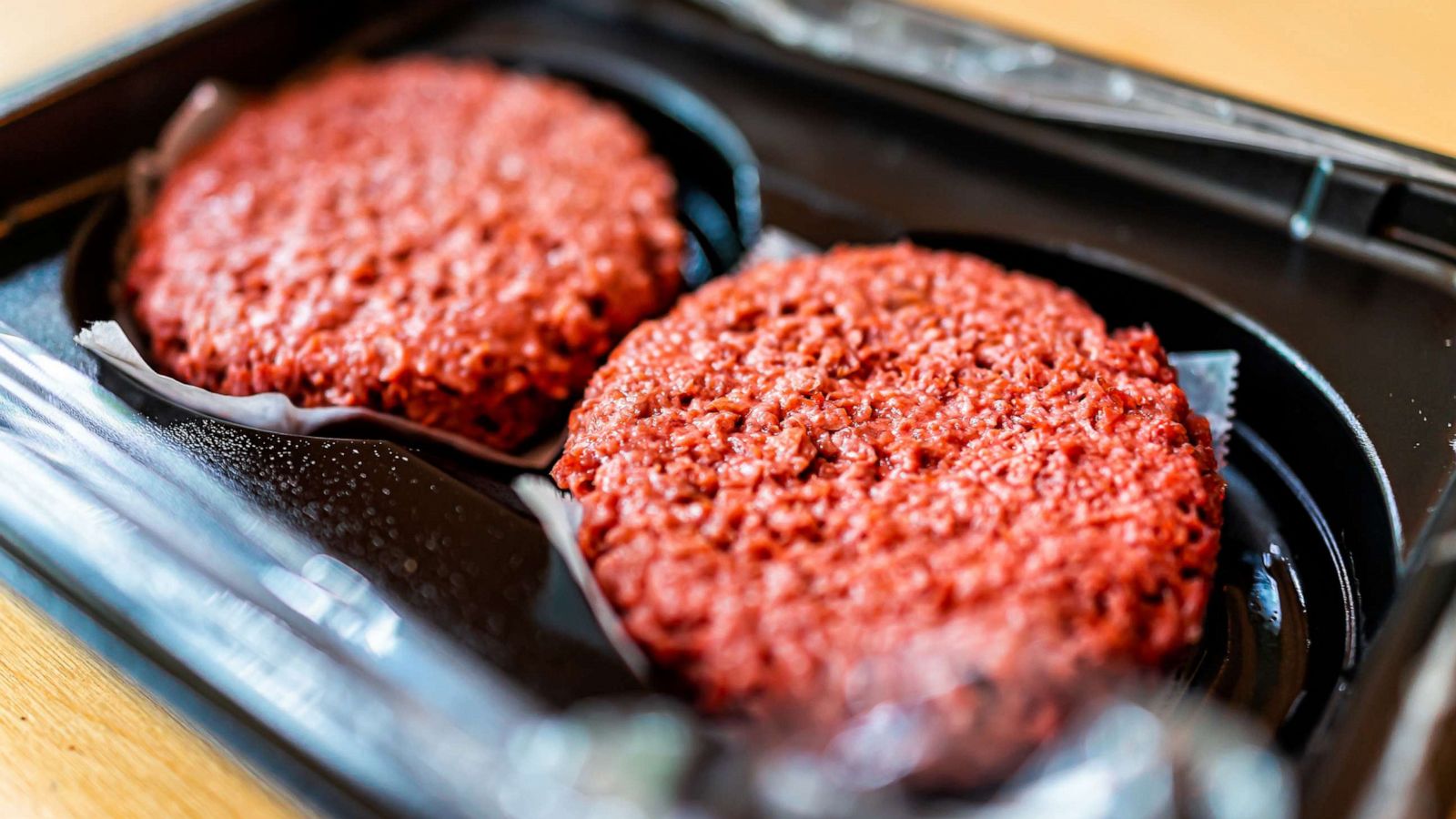 PHOTO: Closeup of two uncooked vegan burger patties.