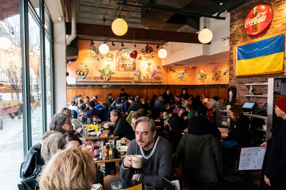 PHOTO: People dine inside Veselka where a Ukrainian flag hangs in the East Village, Feb. 25, 2022, in New York.