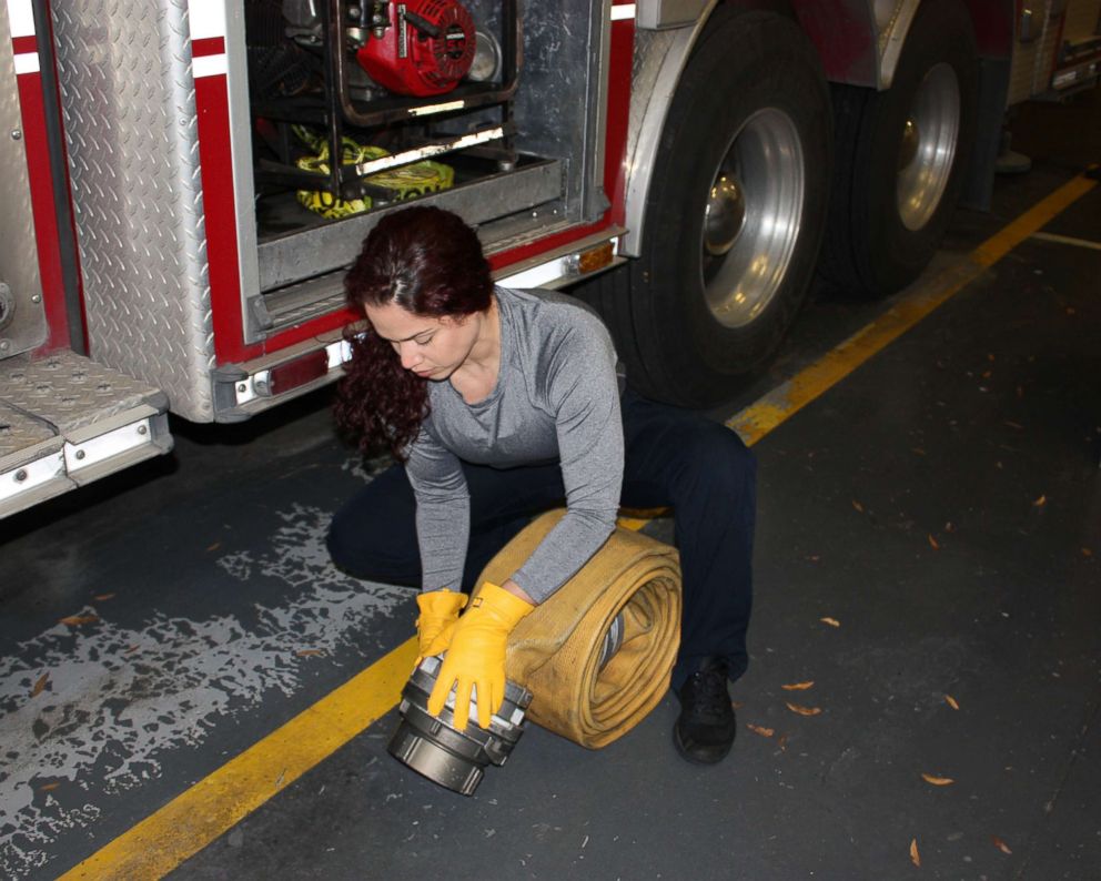 PHOTO: Firefighter paramedic Vivi Rodriguez wearing SeeHerWork gloves while working in the field. 