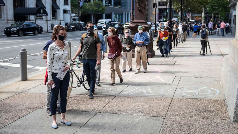 PHOTO: People wait in line to cast their vote during early voting at City Hall in Philadelphia on Oct. 7, 2020.