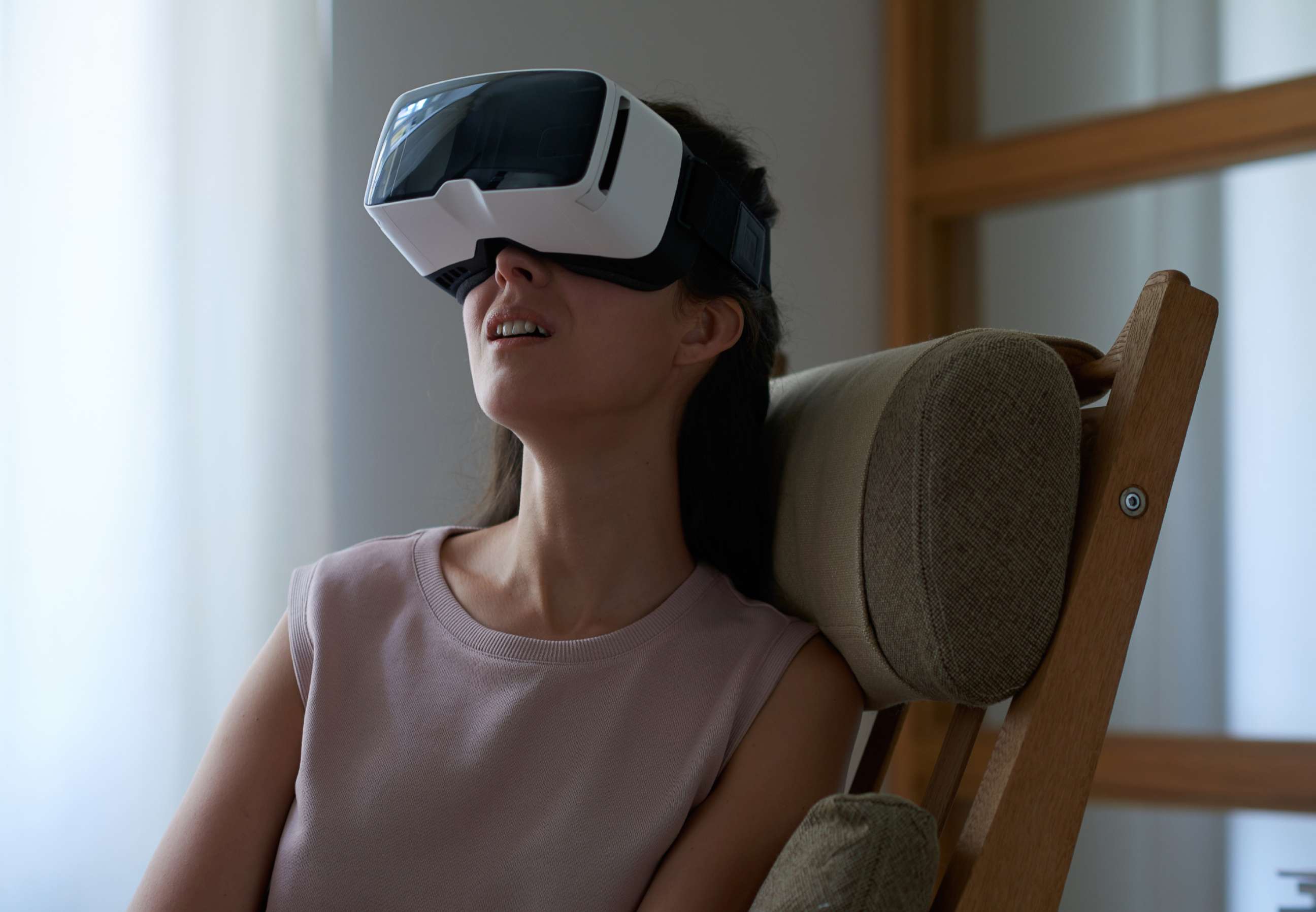 PHOTO: Girl wearing immersive Virtual Reality mask.