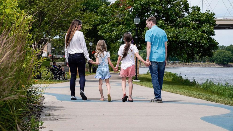 PHOTO: Kelsey and Chris Waits walk with their children in Hastings, Minn., in 2020.