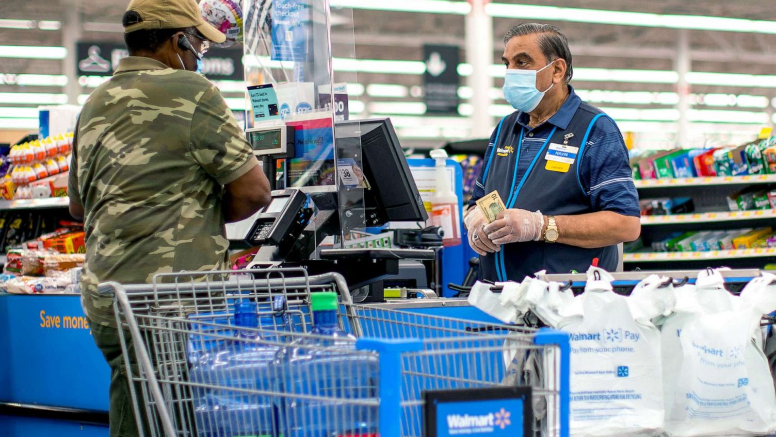 PHOTO: A cashier and a shopper are pictured wearing masks at a Walmart store in North Brunswick, New Jersey, July 20, 2020.