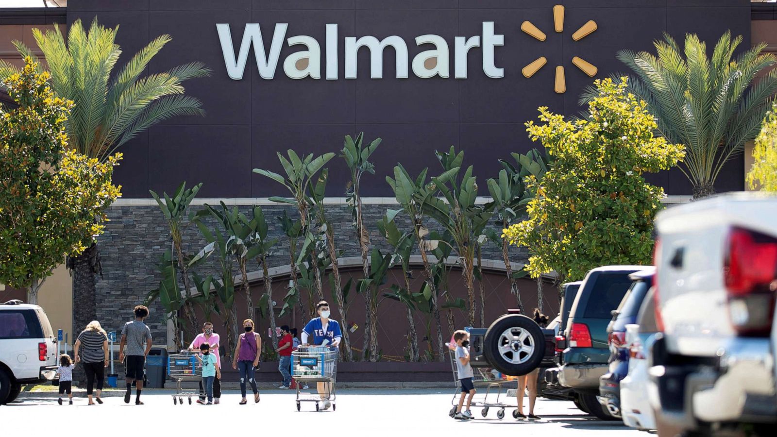 PHOTO: Shoppers wearing face masks are pictured in the parking of a Walmart Superstore in Rosemead, Calif., June 11, 2020.