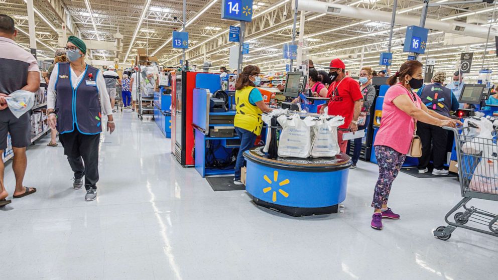 In this May 22, 2021, file photo, shoppers stand in the checkout lines of a Wal-Mart in Miami.