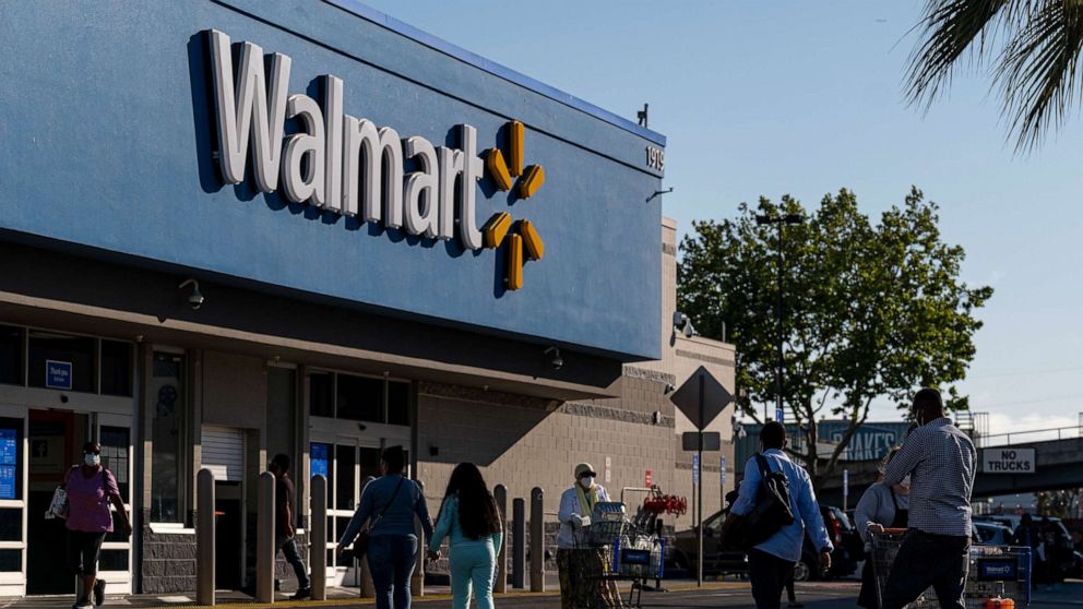 PHOTO: Shoppers walk in front of a Walmart store in San Leandro, Calif., May 13, 2021.