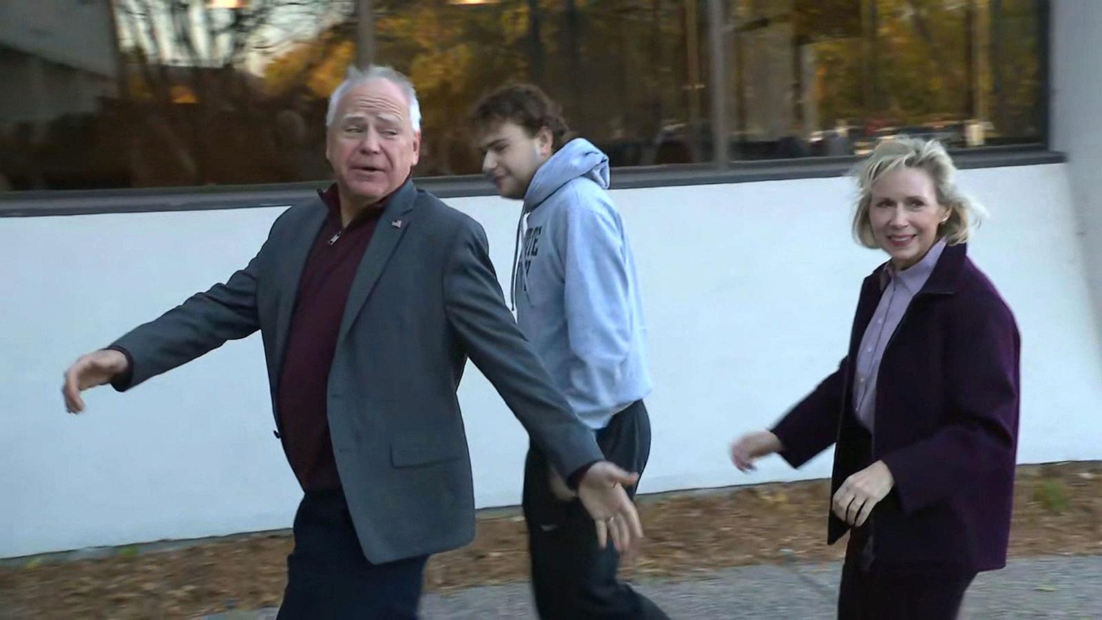 PHOTO: Democratic vice presidential candidate and Minnesota Governor Tim Walz walks with his family to an early voting location, Oct. 23, 2024, in Saint Paul, Minn.