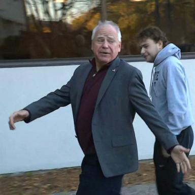 PHOTO: Democratic vice presidential candidate and Minnesota Governor Tim Walz walks with his family to an early voting location, Oct. 23, 2024, in Saint Paul, Minn.