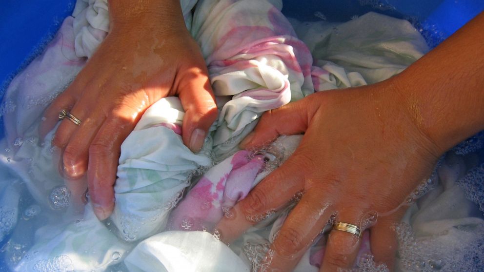 In this undated file photo, a woman washes clothes by hand.