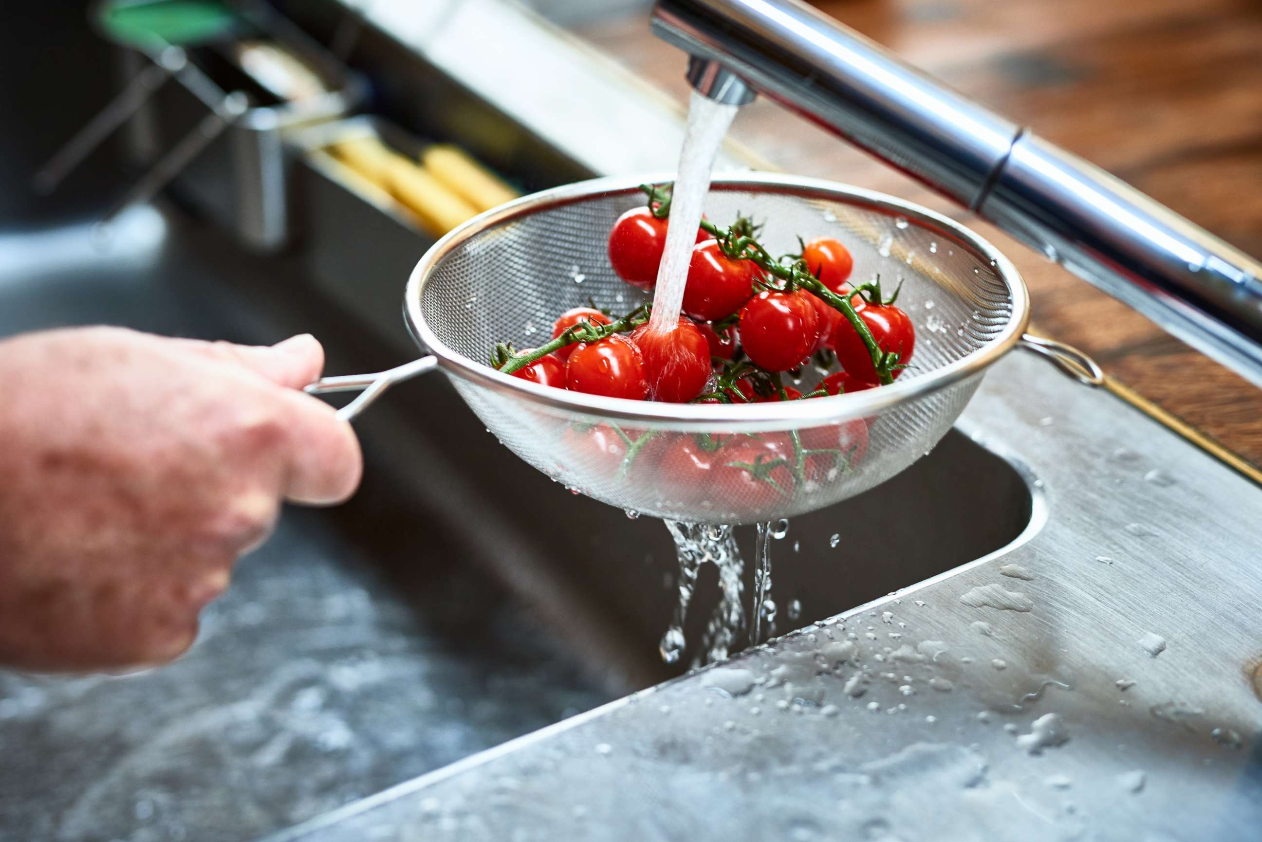 PHOTO: Tomatoes are washed in a sink in this stock photo.