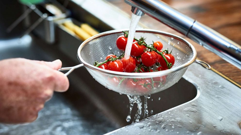 PHOTO: Tomatoes are washed in a sink in this stock photo.