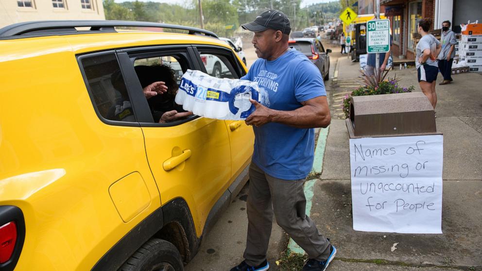 PHOTO: Old Fort Resident Tony J. Daniel, hands out bottled water at the Town Hall on Catawba Avenue in the aftermath of Hurricane Helene on Sept. 30, 2024, in Old Fort, North Carolina.