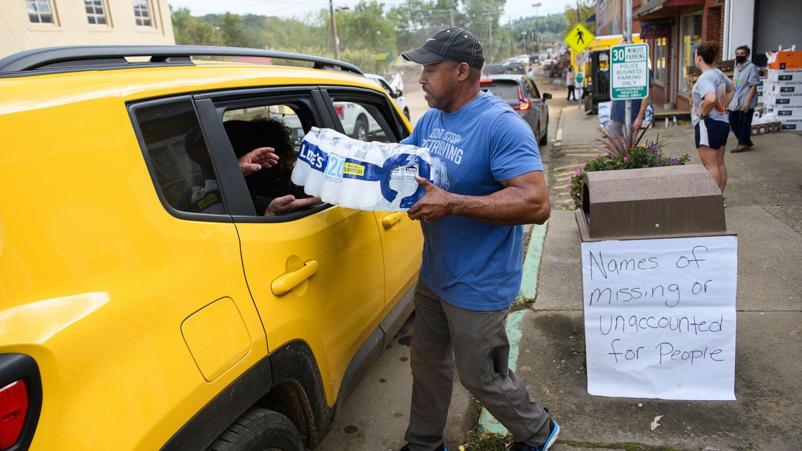 PHOTO: Old Fort Resident Tony J. Daniel, hands out bottled water at the Town Hall on Catawba Avenue in the aftermath of Hurricane Helene on Sept. 30, 2024, in Old Fort, North Carolina.