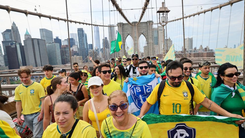 PHOTO: Brazilian soccer fans walk across Brooklyn Bridge in New York City, June 14, 2026.