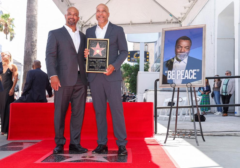 PHOTO: Matthew Weathers and Jason Weathers pose for a photo on the day their father and actor Carl Weathers is honored posthumously with a star on the Hollywood Walk of Fame, in Los Angeles, Aug. 29, 2024. 