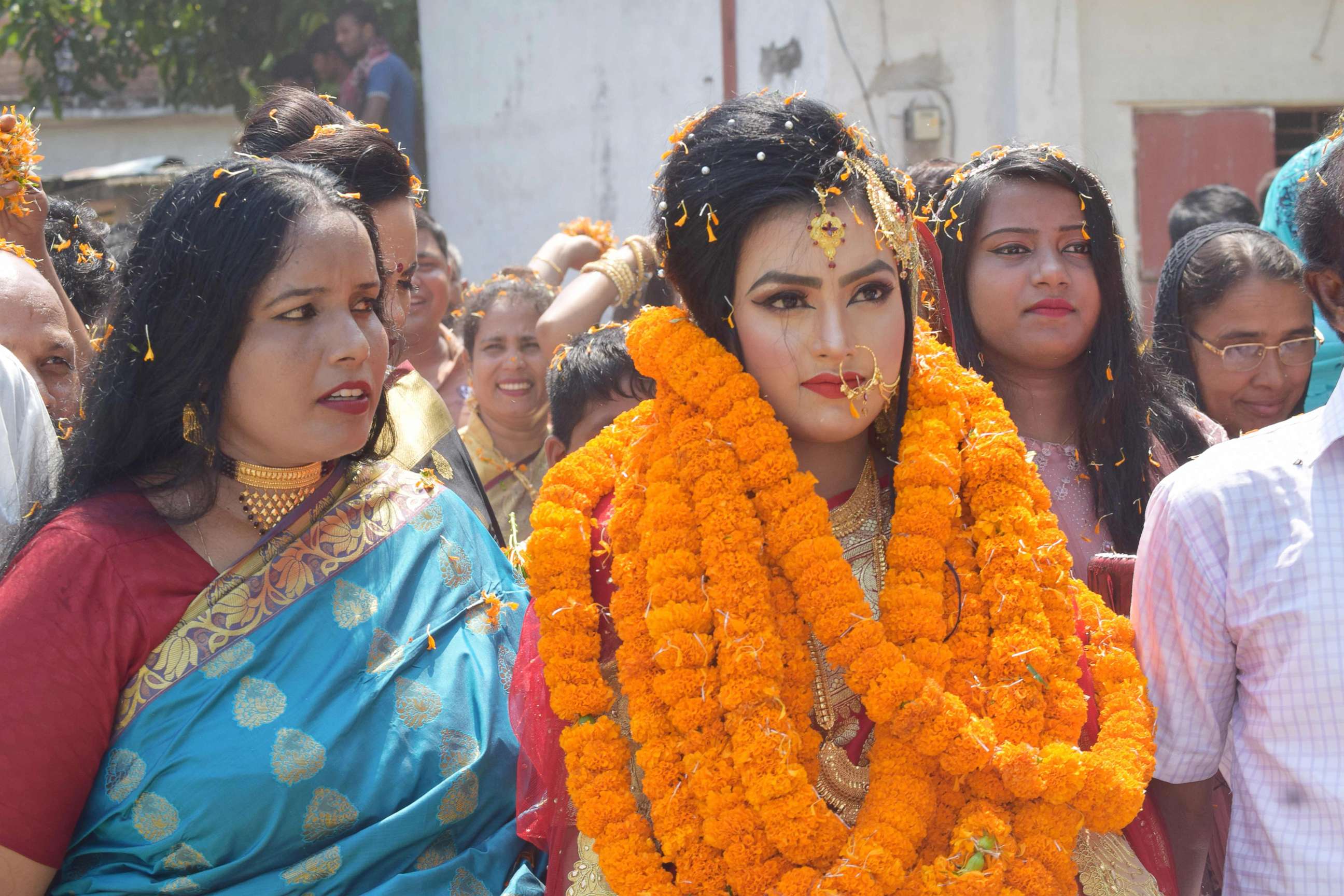 PHOTO:Relatives of groom Tariqul Islam welcome bride Khadiza Akter Khushi with a floral wreath as she arrives to groom's house during their wedding in Meherpur, Sept. 21, 2019.