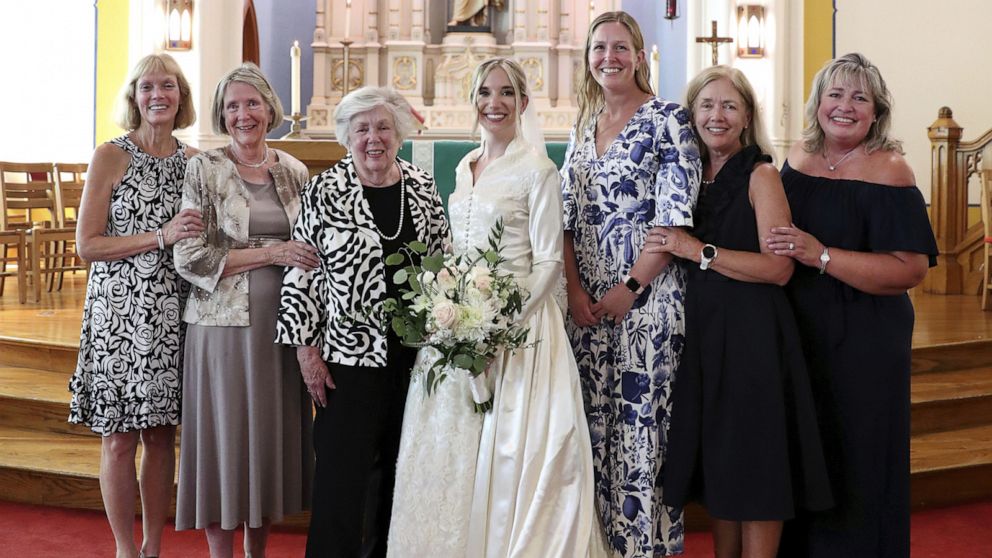PHOTO: Bride Serena Stoneberg, center, stands with six women in her family who have all worn the same wedding dress, at Ebenezer Lutheran Church in Chicago, Aug. 5, 2022. 
