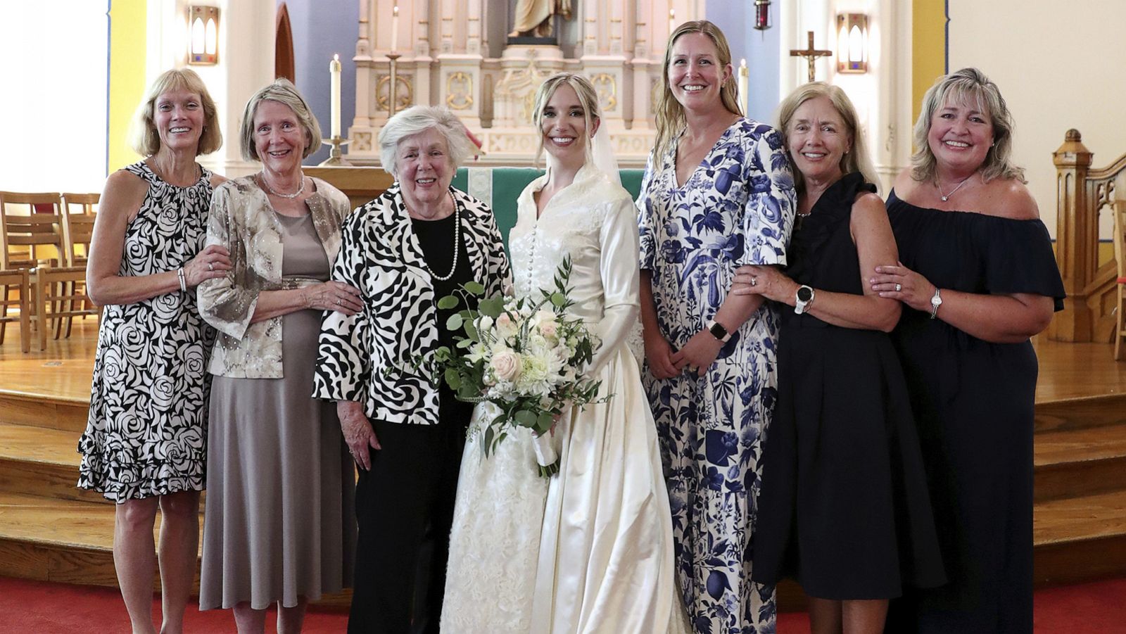 PHOTO: Bride Serena Stoneberg, center, stands with six women in her family who have all worn the same wedding dress, at Ebenezer Lutheran Church in Chicago, Aug. 5, 2022.