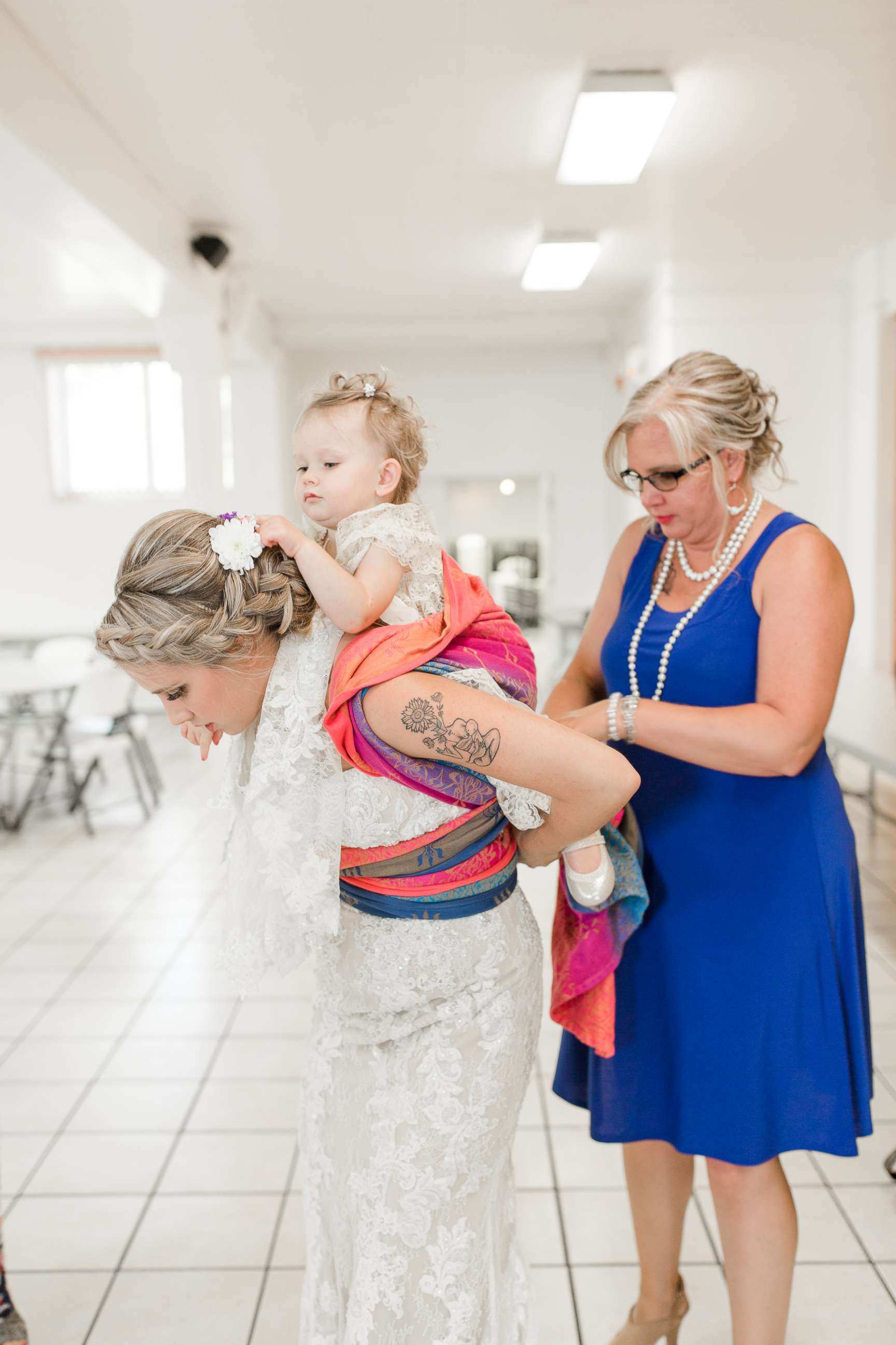 PHOTO: Dalton Butts is pictured wearing her baby Elllora at her wedding. 