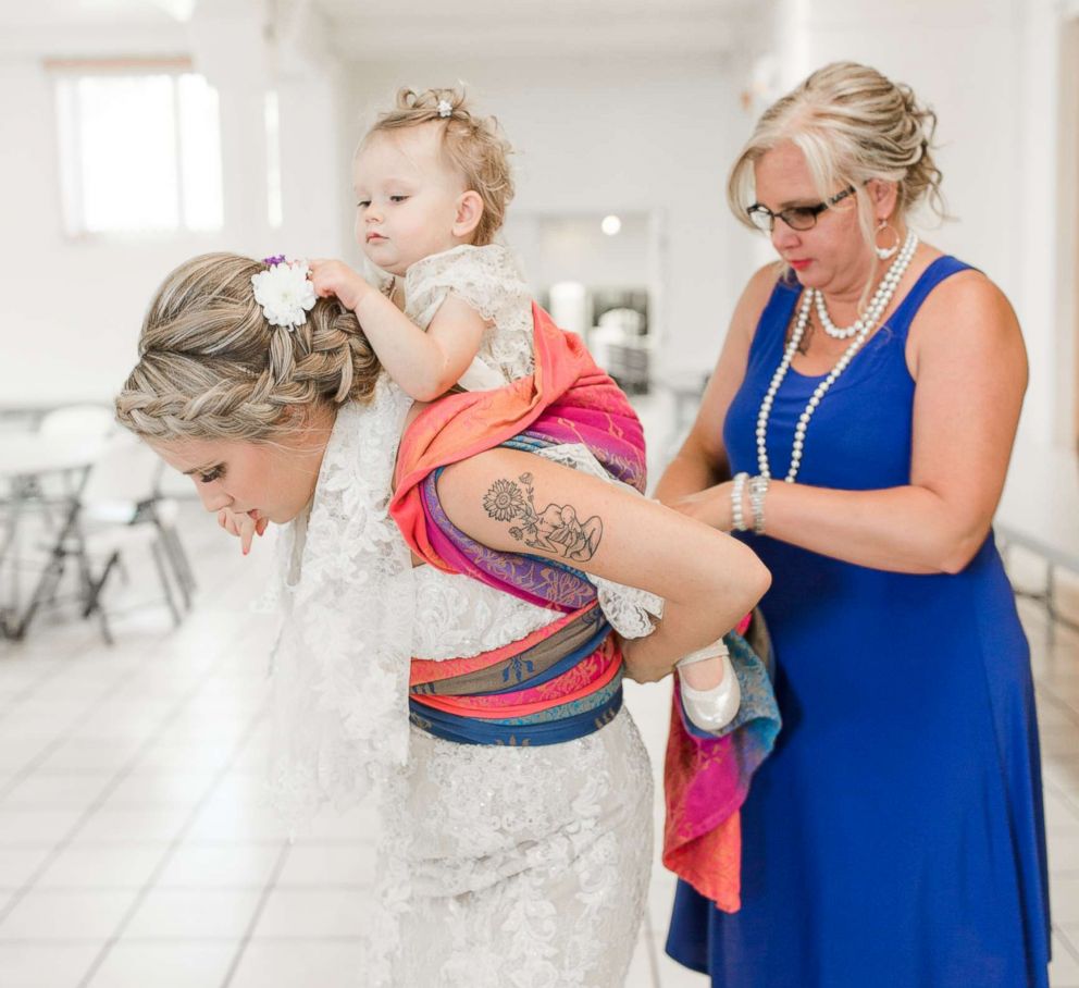 PHOTO: Dalton Butts is pictured wearing her baby Elllora at her wedding. 