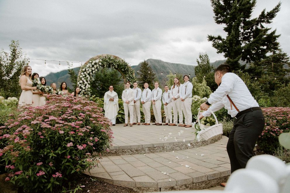 PHOTO: Lily Tran's "flower man" sprinkles flower petals along her aisle on her wedding in Washington.