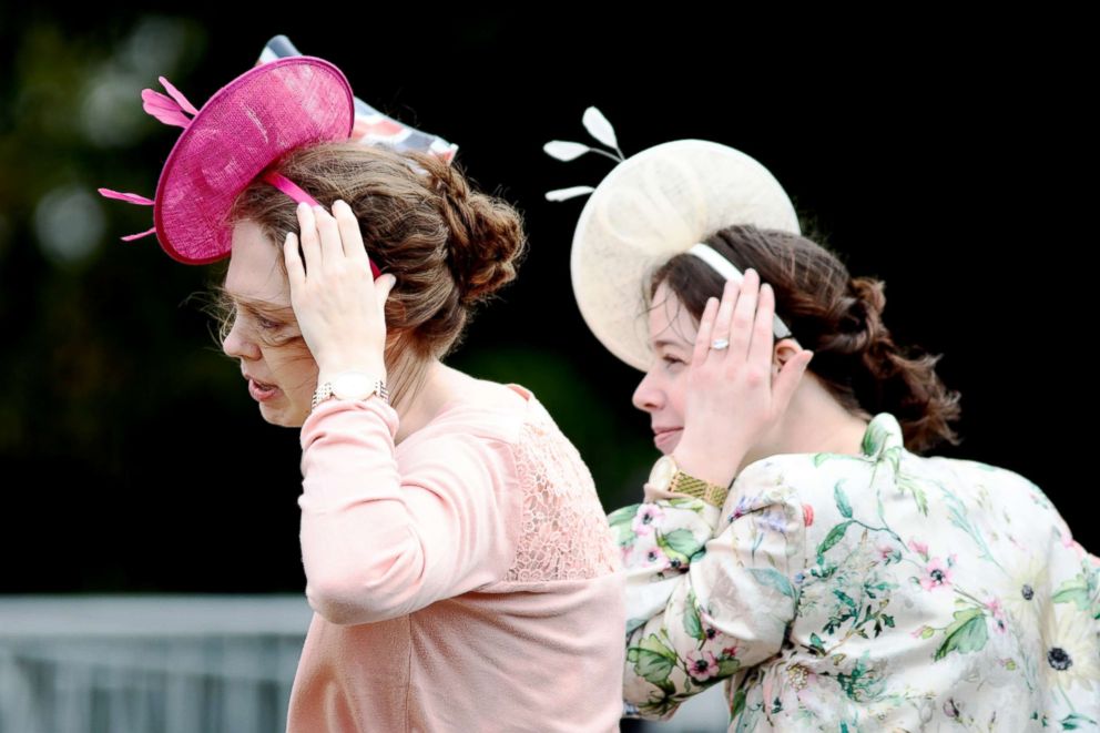 PHOTO: The wind blows as women try to keep their hats on their heads ahead of the Royal wedding of Princess Eugenie of York and Mr. Jack Brooksbank at St. George's Chapel, Oct. 12, 2018, in Windsor, England.