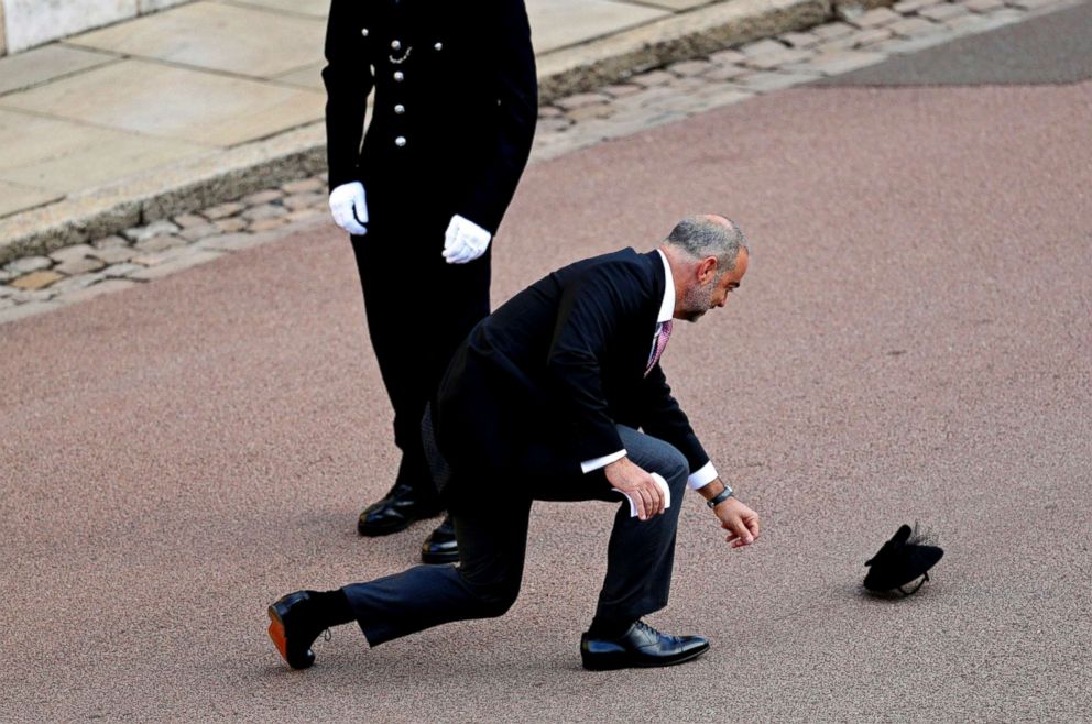 PHOTO: A guest loses a hat in the wind as he arrives for the wedding of Princess Eugenie of York and Jack Brooksbank at St George's Chapel, Windsor Castle, near London, Oct. 12, 2018.