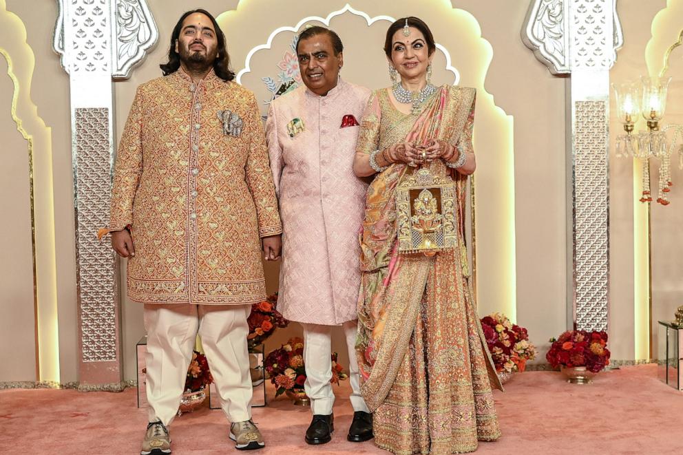 PHOTO: Billionaire tycoon and Chairman of Reliance Industries Mukesh Ambani with his wife Nita Ambani and son Anant Ambani poses for photos as they arrive to attend the wedding ceremony of Anant and his fiancee Radhika Merchant in Mumbai on July 12, 2024.