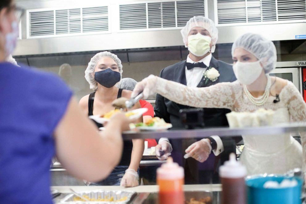 PHOTO:  Tyler and Melanie Tapajna in the kitchen at The City Mission in Cleveland, Ohio on their wedding day.
