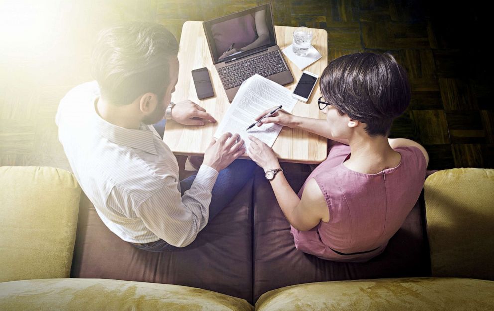 PHOTO: A man and woman pose reading  papers in an undated stock image.