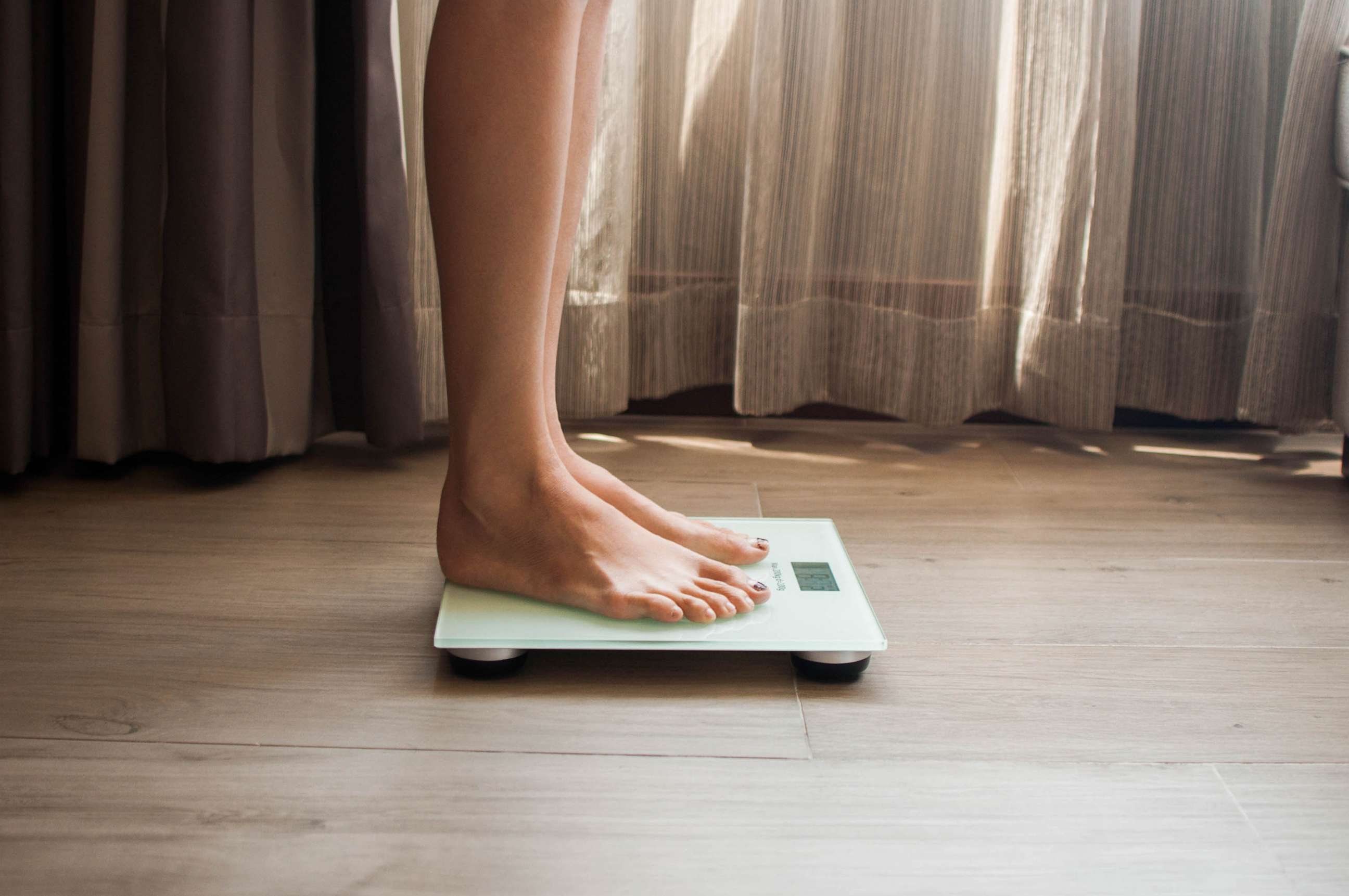 STOCK PHOTO: A woman on a weighing scale