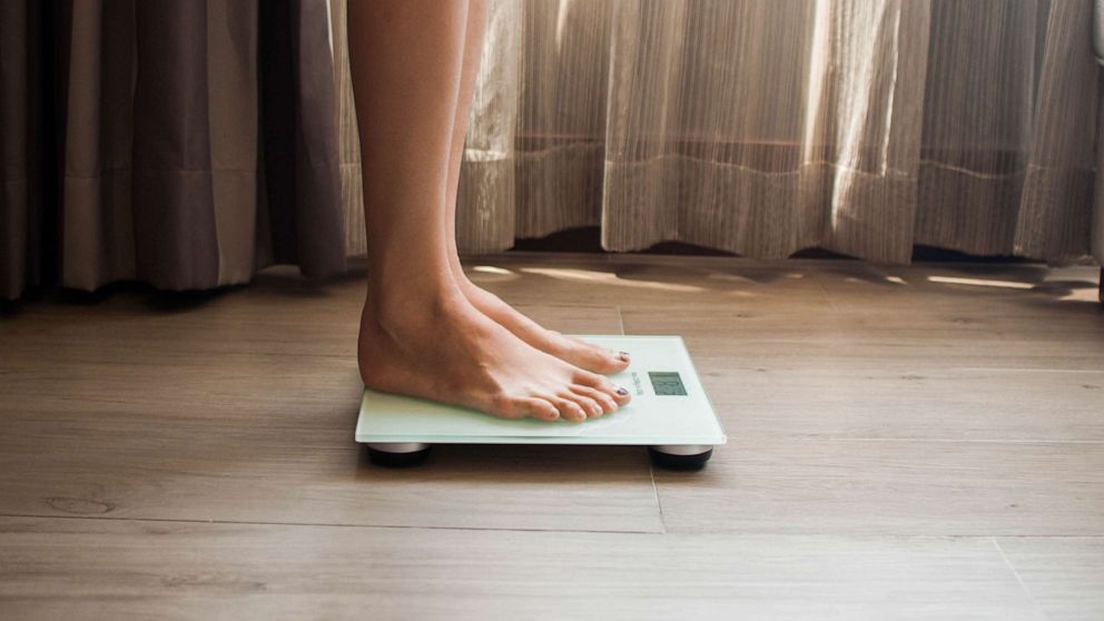 STOCK PHOTO: A woman on a weighing scale