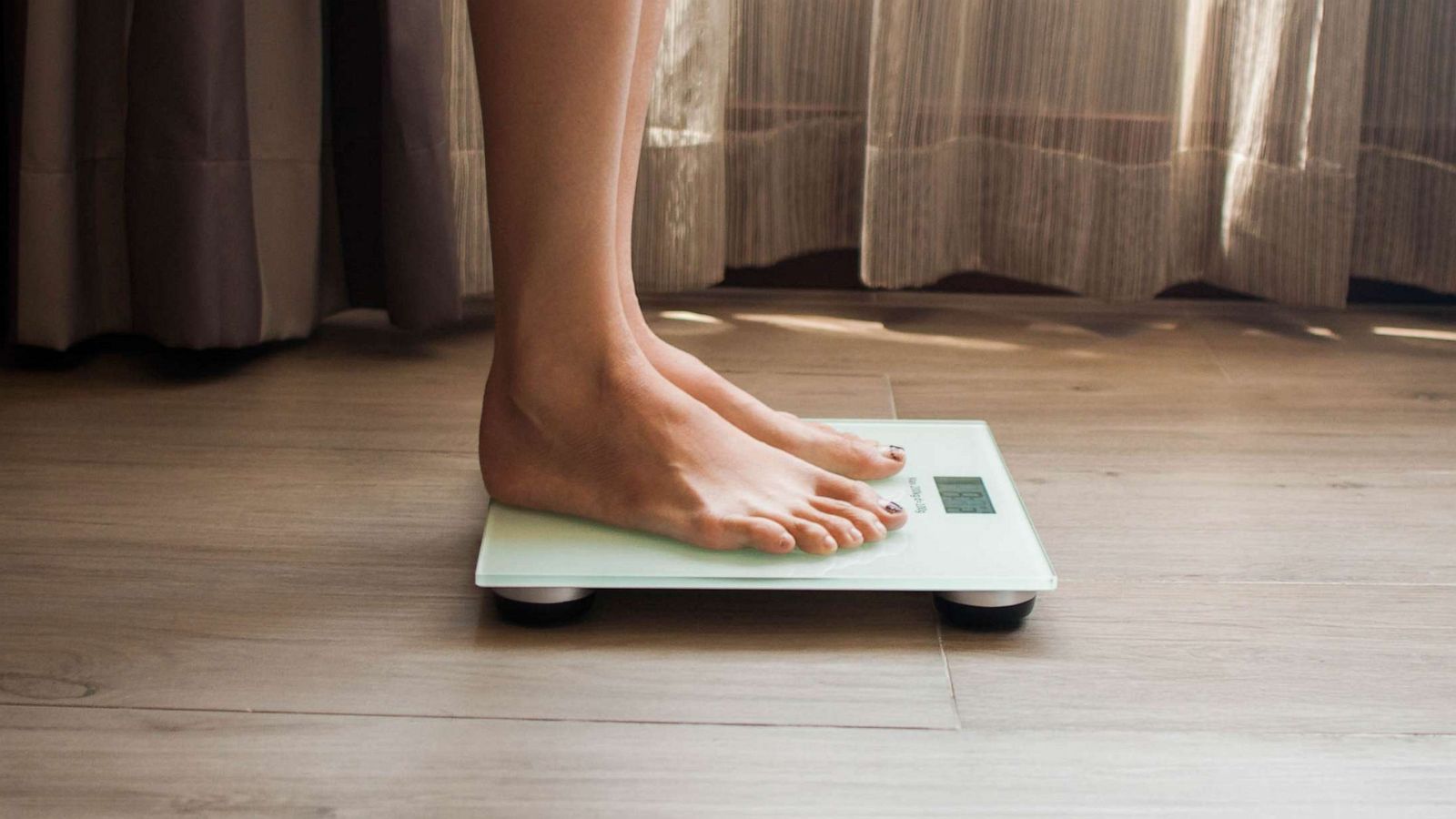 STOCK PHOTO: A woman on a weighing scale