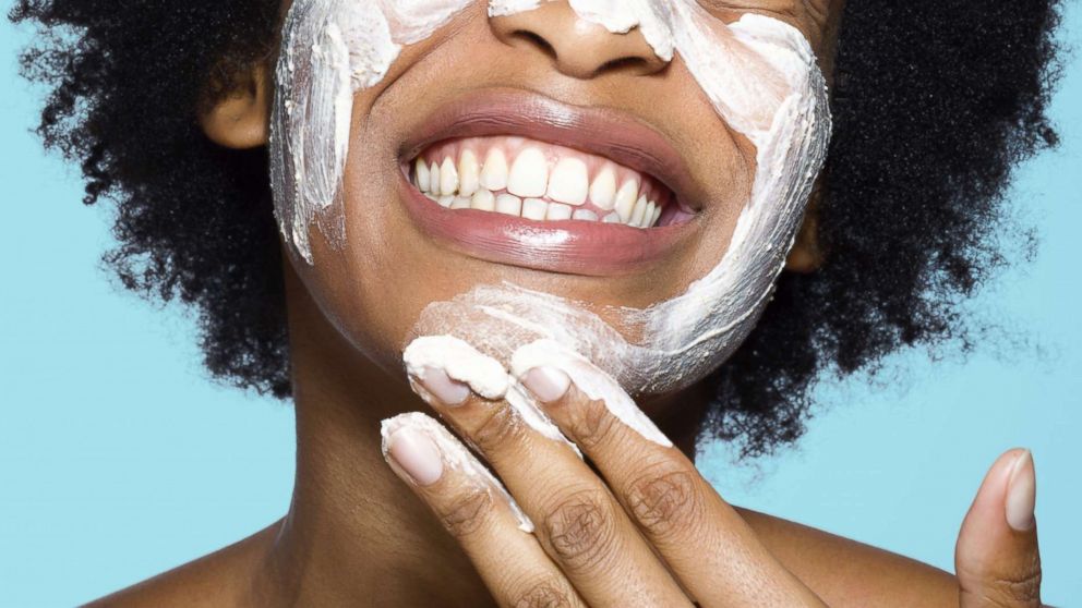 A woman applies a face mask in an undated stock photo.