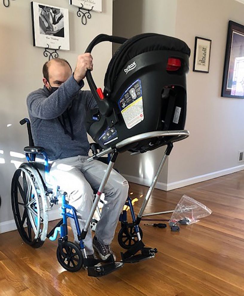 PHOTO: Jeremy King attaching his son's car seat to his wheelchair at their Germantown, Md., home.