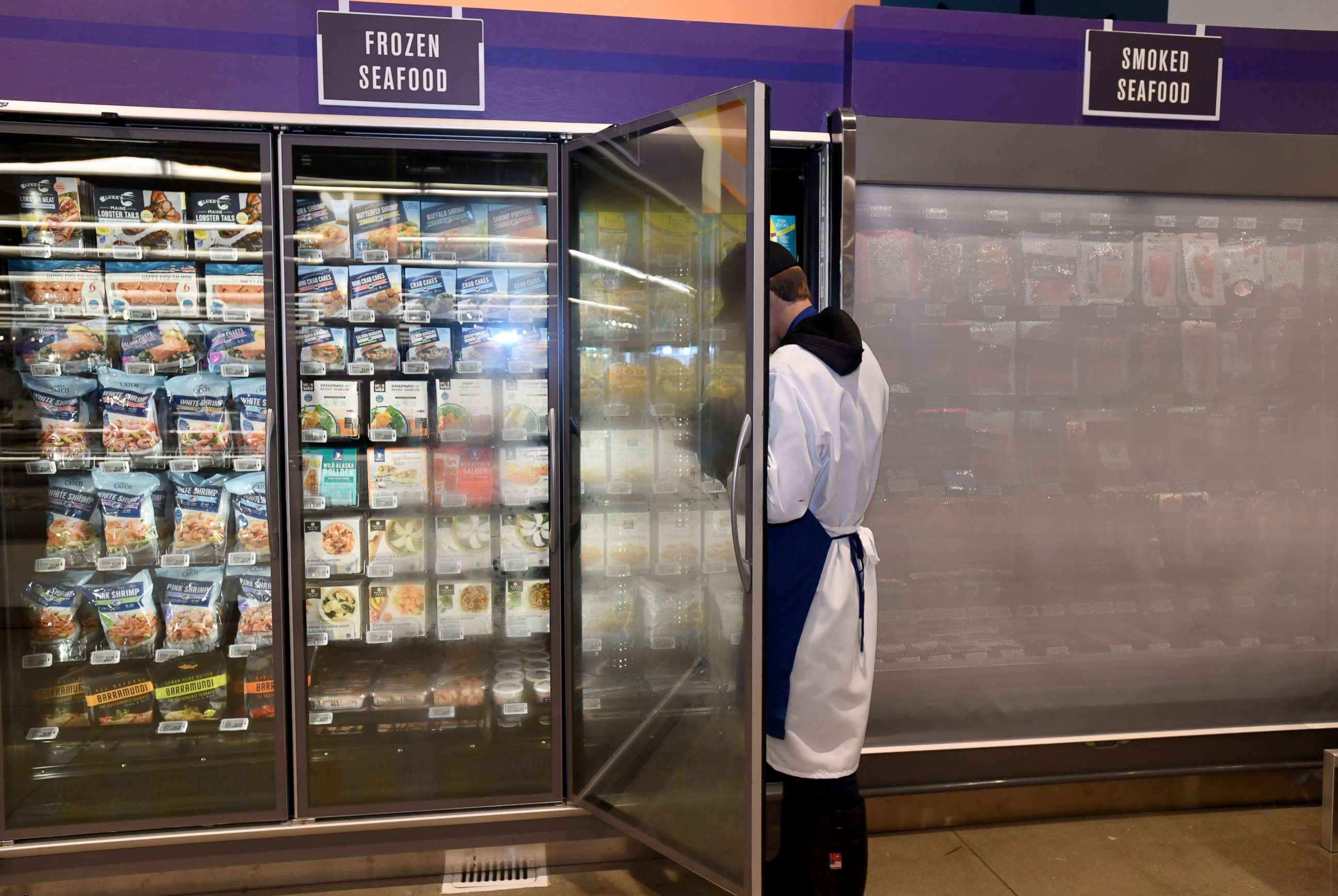 PHOTO: A store employee works in the frozen seafood section at a Whole Foods in Long Beach, Calif., Oct. 22, 2019.
