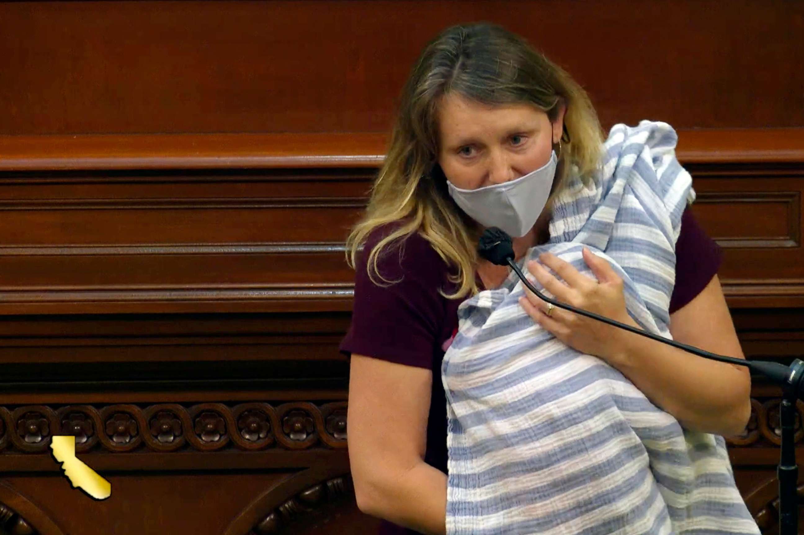 PHOTO: Assemblywoman Buffy Wicks, a Democrat from Oakland, addresses lawmakers on a housing bill while holding her one-month-old daughter Elly in her arms during the final hours of the California legislative session, Aug. 31, 2020, in Sacramento, Calif.