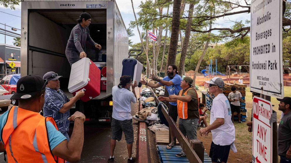 PHOTO: Volunteers unload ice and cooler donations at a distribution center for those affected by the Maui fires at Honokawai Beach Park in Napili-Honokowai, west of Maui, Hawaii, Aug. 14, 2023.