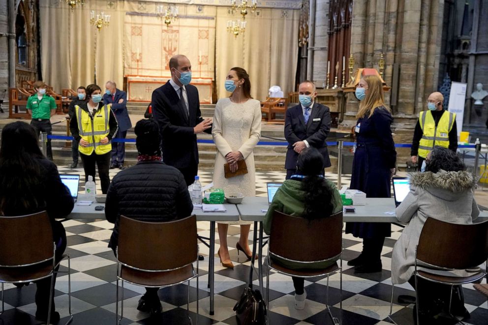PHOTO: Britain's Prince William and Catherine, Duchess of Cambridge, speak to staff during a visit at a coronavirus disease (COVID-19) vaccination centre at Westminster Abbey, in London, March 23, 2021.