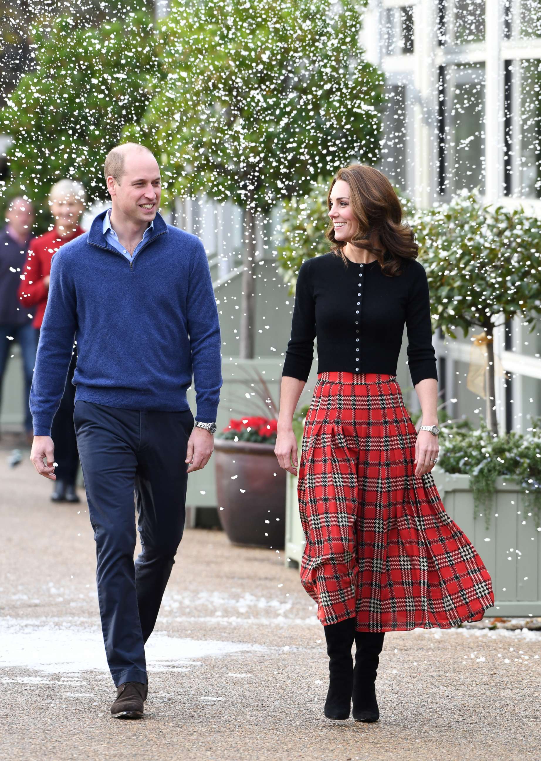 PHOTO: Prince William, Duke of Cambridge and Catherine, Duchess of Cambridge laugh as a machine sprays snow at Kensington Palace, Dec. 4, 2018, in London. 
