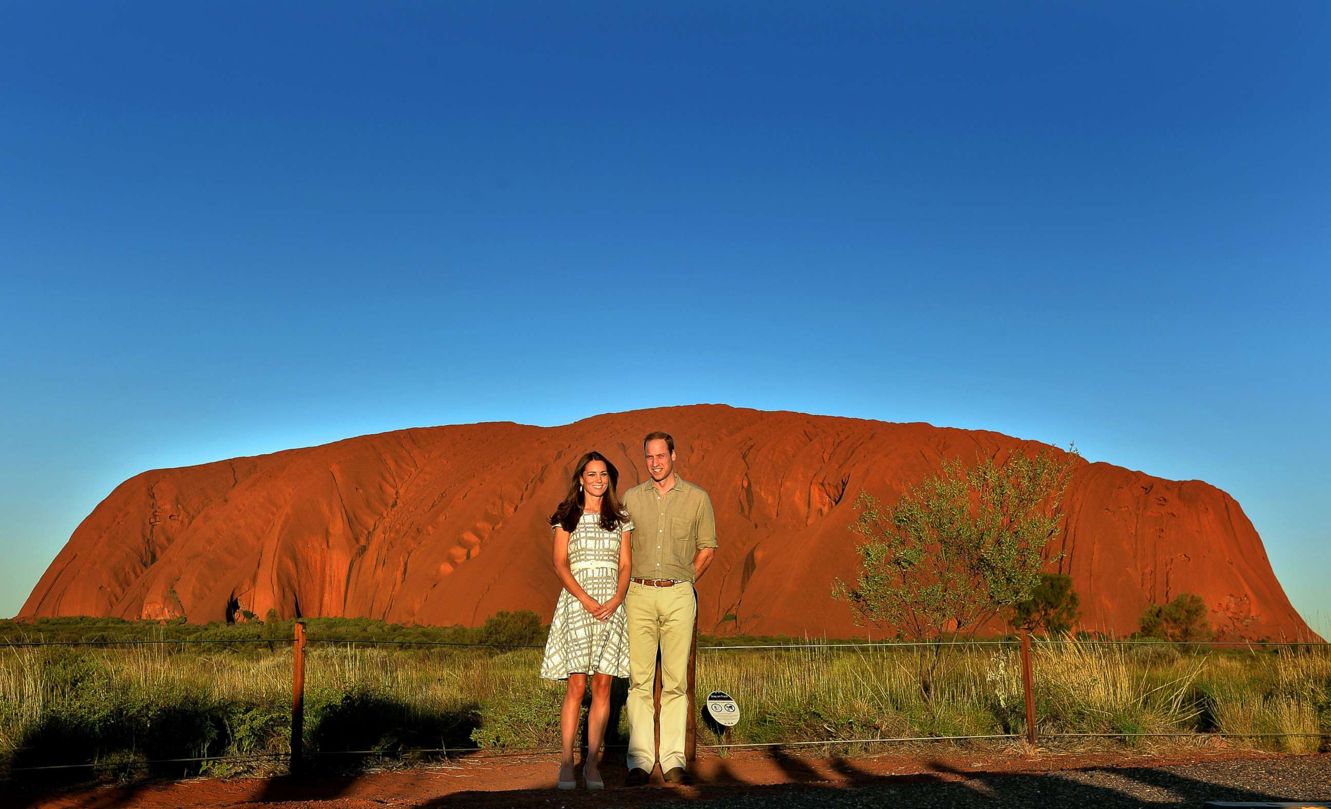 PHOTO: Catherine, Duchess of Cambridge and Prince William, Duke of Cambridge pose in front of Uluru, also known as Ayers Rock, on April 22, 2014, in Ayers Rock, Australia.