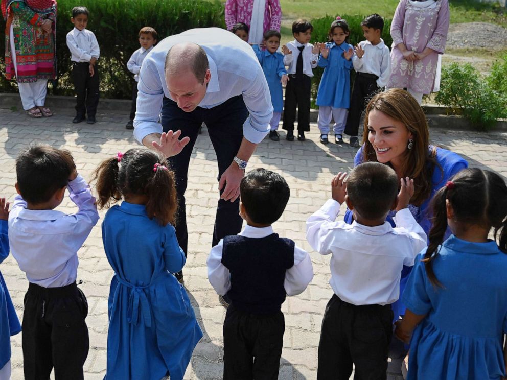 PHOTO: Britains Prince William, Duke of Cambridge, and his wife Catherine, Duchess of Cambridge, meet with school children during their visit to a government-run school in Islamabad, Oct. 15, 2019.