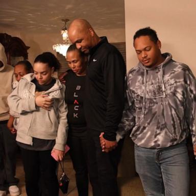 PHOTO: The Williams family prays before having dinner after losing their homes in the California wildfires.