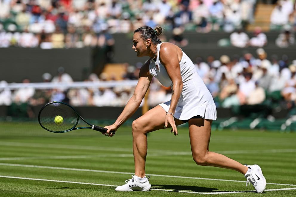 PHOTO: Aryna Sabalenka plays a backhand against Carson Branstine of Canada during their Ladies' Singles first round Wimbledon Championships match, June 30, 2025, in London.