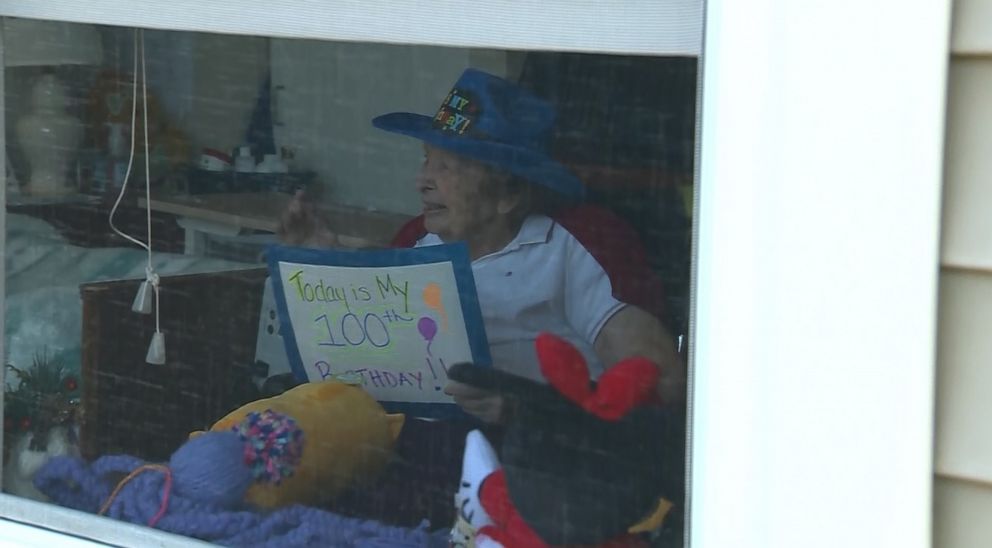 PHOTO: Millie Erickson, a resident of Sterling Village in Massachusetts, was greeted by family near a window March 15 to celebrate her 100th birthday. Sterling Village had to tighten its visitation policy due to the coronavirus pandemic.