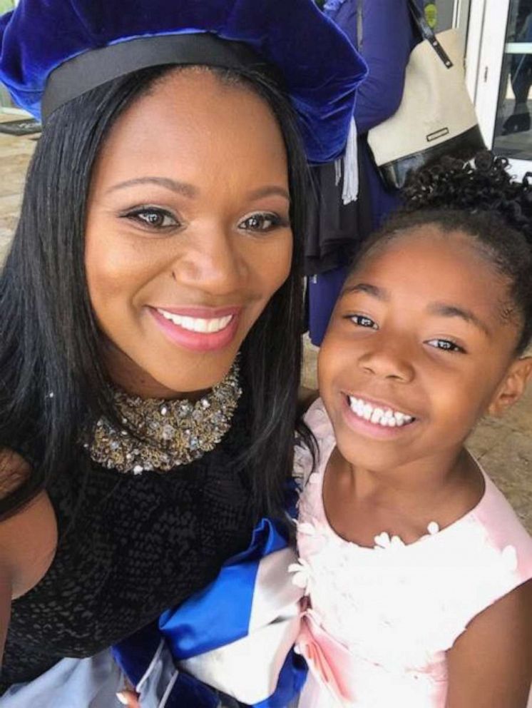 Yolanda Perkins poses with her daughter, Bella, 6, during her graduation in Florida.