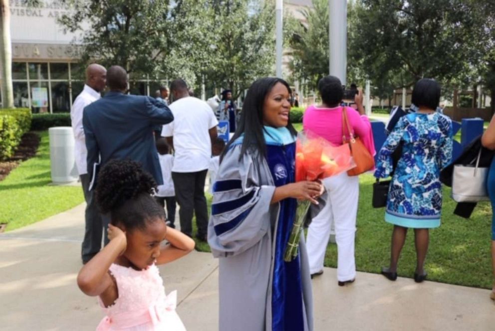 PHOTO: On June 14, Yolanda Perkins walked across the stage during commencement at Nova Southeastern University and accepted her PhD as her family looked on.